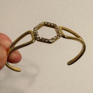 Gold metal bracelet with crystals.